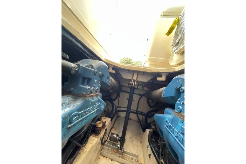 Slide: The Image of Engine compartment of a 1997 Tiara Yachts 3100 Open, showcasing dual blue engines. - 30