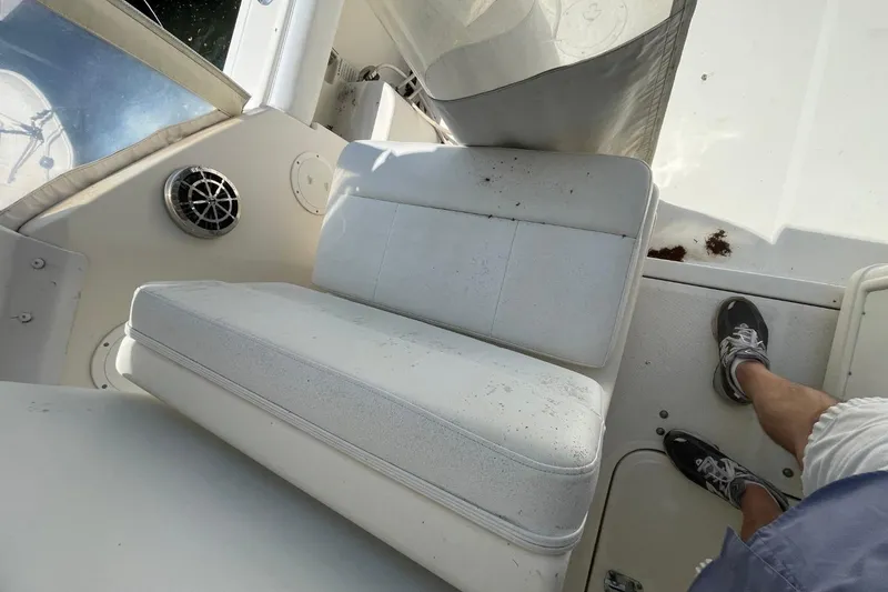 Slide: The Image of 1997 Tiara Yachts 3100 Open interior with white seating and speaker detail. - 31