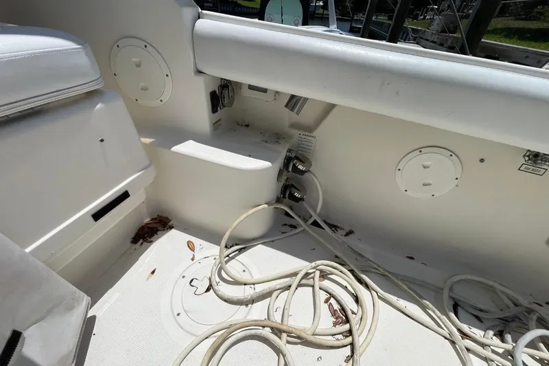 Slide: The Image of 1997 Tiara Yachts 3100 Open cockpit with cables and storage compartments. - 32