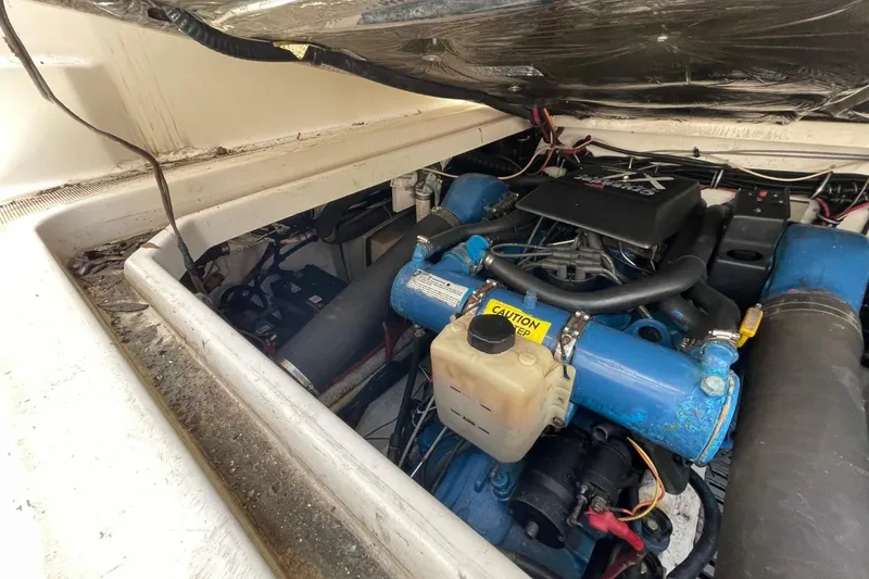 Slide: The Image of Engine compartment of a 1997 Tiara Yachts 3100 Open, showcasing blue engine components. - 34