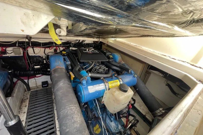 Slide: The Image of Engine compartment of a 1997 Tiara Yachts 3100 Open, showcasing mechanical components and wiring. - 35