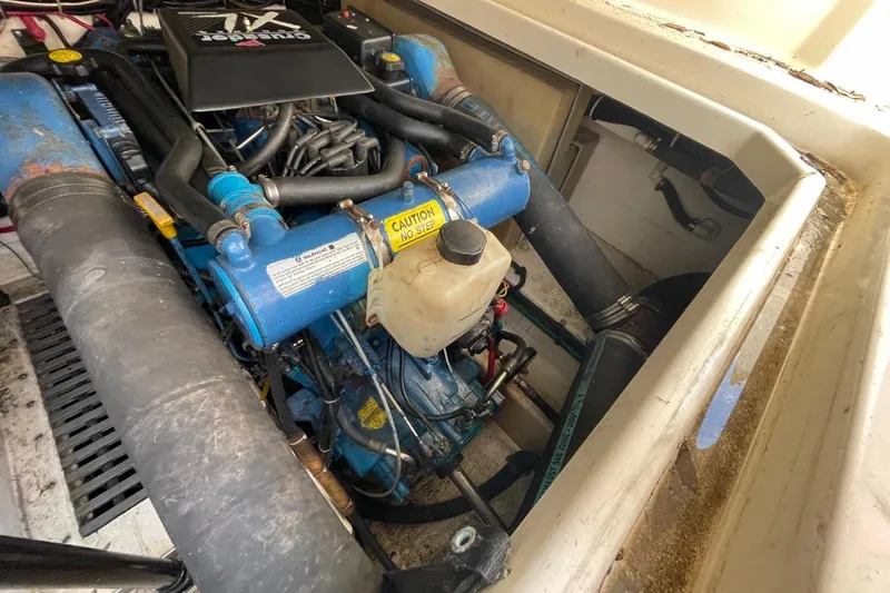 Slide: The Image of Engine compartment of a 1997 Tiara Yachts 3100 Open, featuring a Quicksilver marine engine. - 36