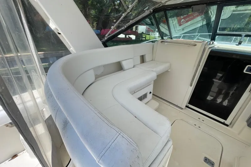 Slide: The Image of Interior of a 1997 Tiara Yachts 3100 Open, featuring white seating and helm area. - 8