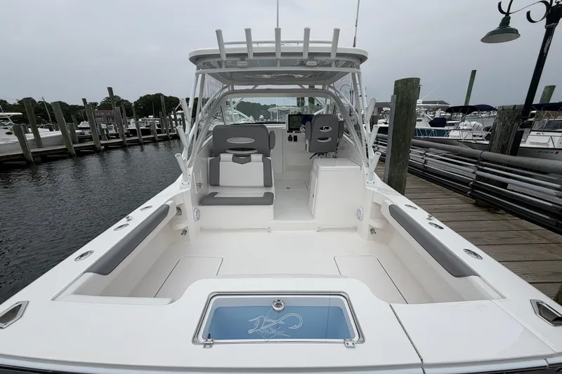 Slide: The Image of 2024 Albemarle 30 Express boat docked, showcasing spacious deck and seating area. - 23