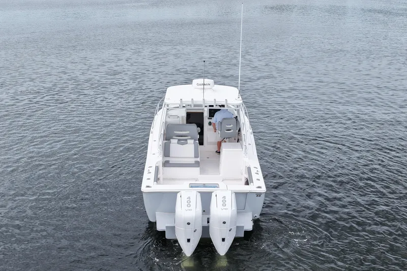 Slide: The Image of 2024 Albemarle 30 Express boat on water, rear view with dual engines. - 12