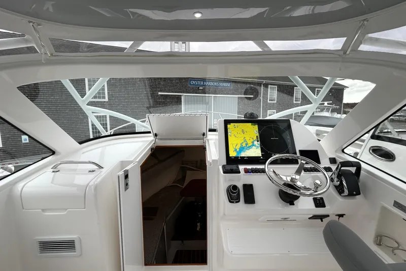Slide: The Image of 2024 Albemarle 30 Express helm with navigation display and steering wheel. - 20