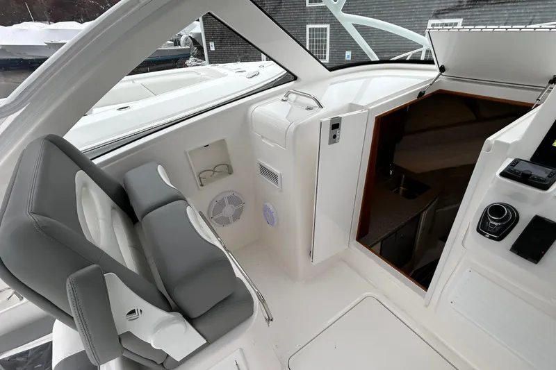 Slide: The Image of 2024 Albemarle 30 Express boat interior with helm seat and cabin entrance. - 23