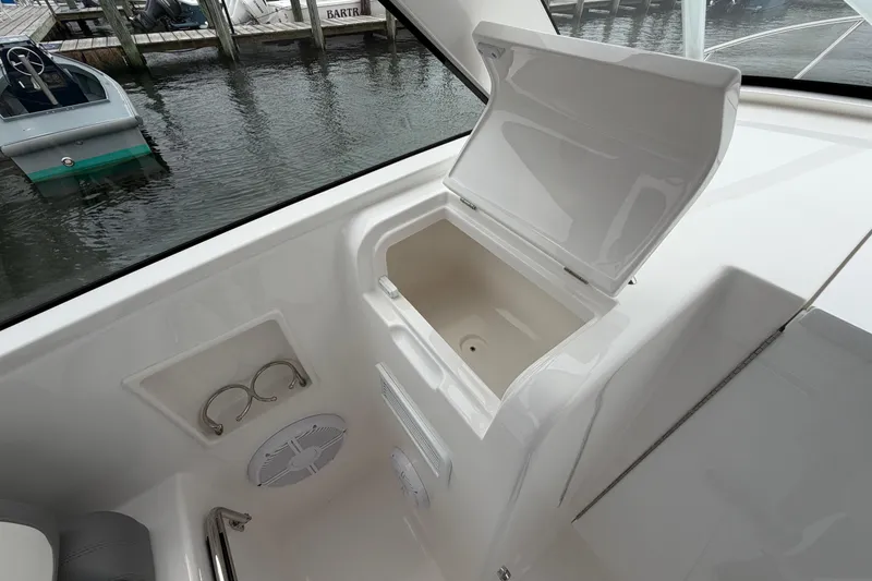 Slide: The Image of 2024 Albemarle 30 Express boat interior with open storage compartment and cup holders. - 54