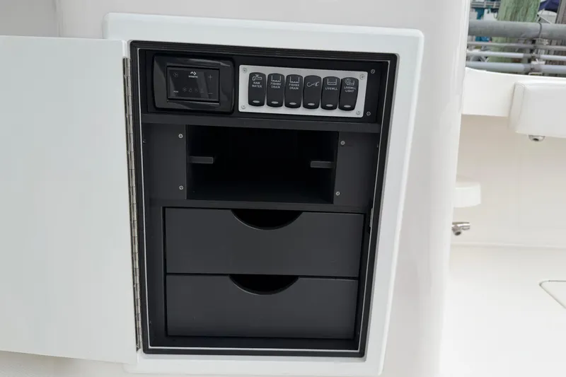 Slide: The Image of Control panel and storage drawers on 2024 Albemarle 30 Express boat. - 30