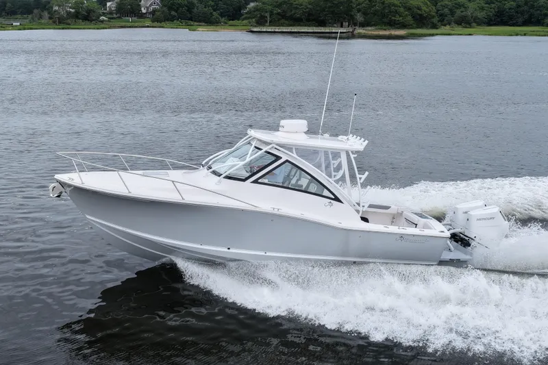 The Image of 2024 Albemarle 30 Express boat cruising on a serene lake. - 0