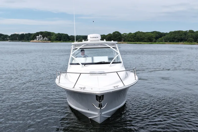 Slide: The Image of 2024 Albemarle 30 Express boat on calm water, front view. - 2