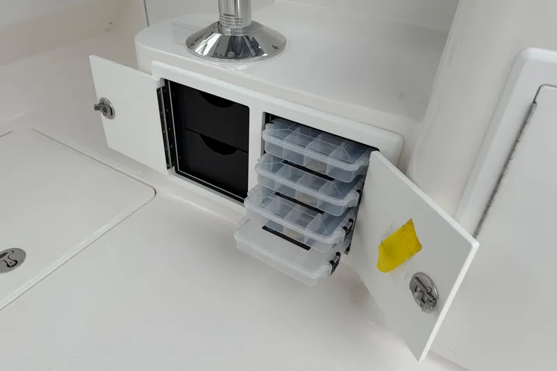 Slide: The Image of Storage compartment with tackle boxes on a 2024 Albemarle 30 Express boat. - 35