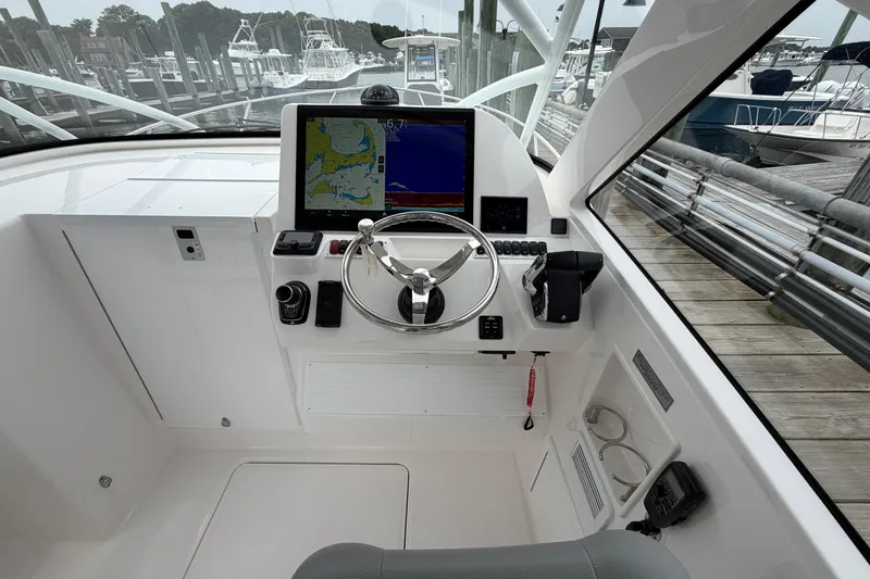 Slide: The Image of Helm of 2024 Albemarle 30 Express boat with navigation display and steering wheel. - 44