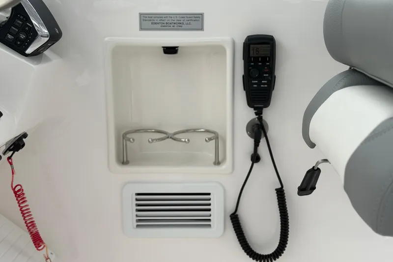 Slide: The Image of 2024 Albemarle 30 Express boat interior with radio and cup holders. - 51
