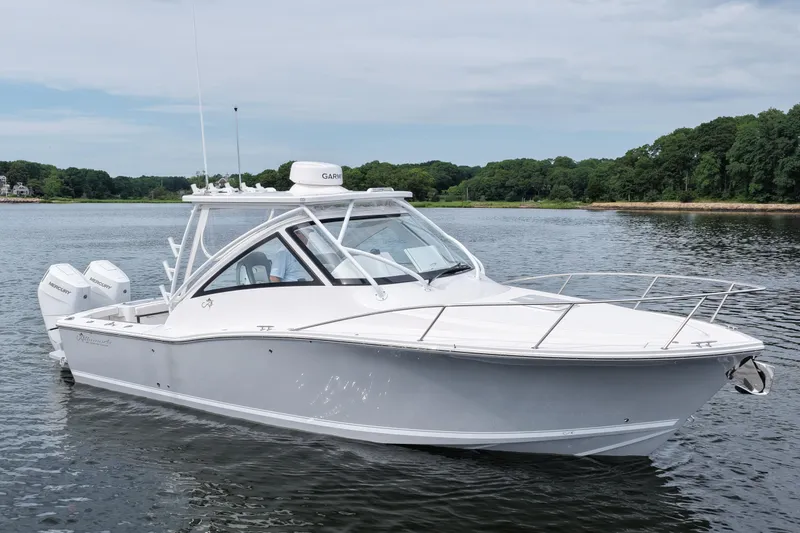 Slide: The Image of 2024 Albemarle 30 Express boat on calm water, featuring sleek design and twin Mercury engines. - 4