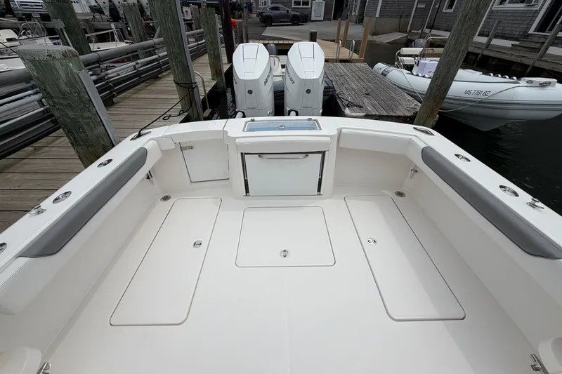 Slide: The Image of 2024 Albemarle 30 Express boat deck with twin engines at dock. - 16