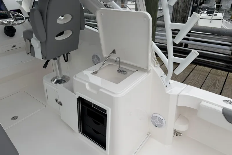 Slide: The Image of 2024 Albemarle 30 Express boat interior with sink, seating, and storage. - 29