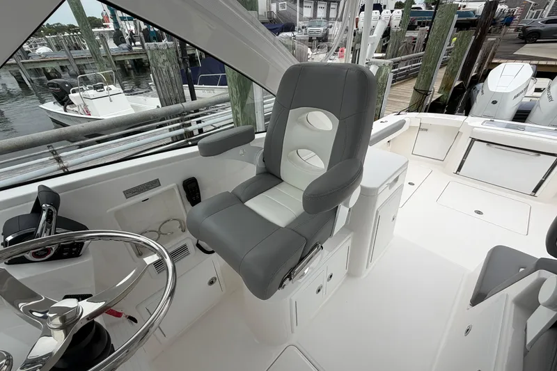 Slide: The Image of 2024 Albemarle 30 Express boat interior with helm seat and steering wheel. - 56