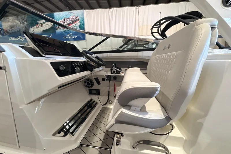 Slide: The Image of 2026 Sea Ray SLX 310 Outboard helm with luxurious seating and modern controls. - 10