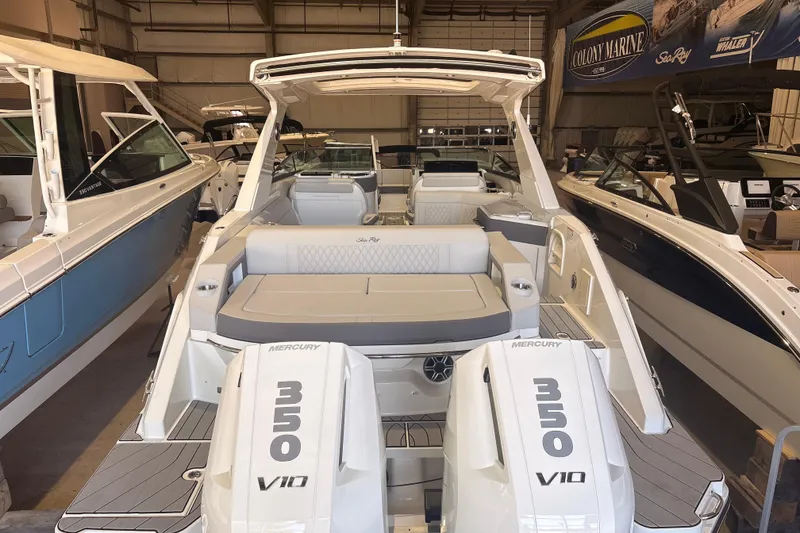 Slide: The Image of 2026 Sea Ray SLX 310 Outboard boat with dual Mercury 350 V10 engines in showroom. - 12