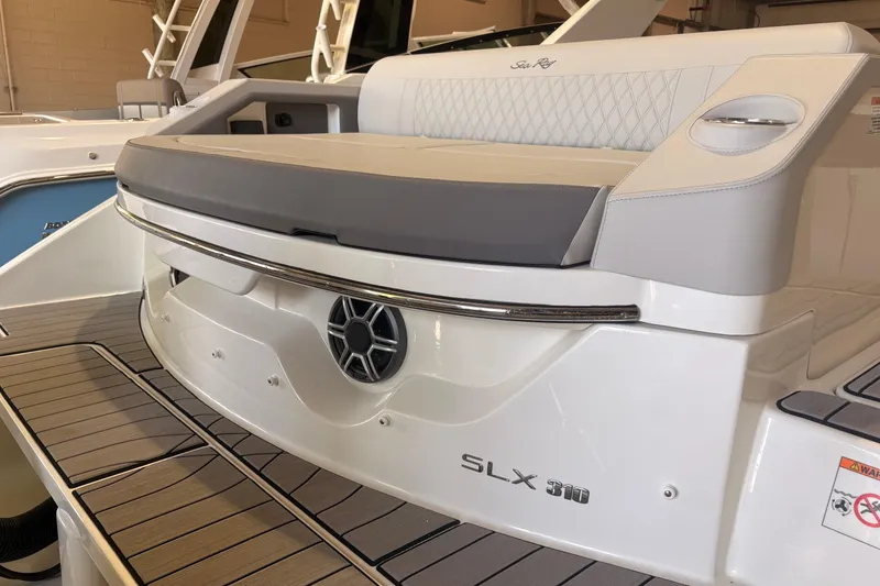 Slide: The Image of 2026 Sea Ray SLX 310 Outboard boat with sleek seating and modern design. - 23