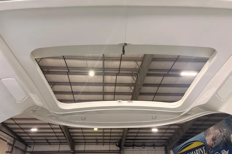 Slide: The Image of 2026 Sea Ray SLX 310 Outboard boat roof detail in a showroom setting. - 25