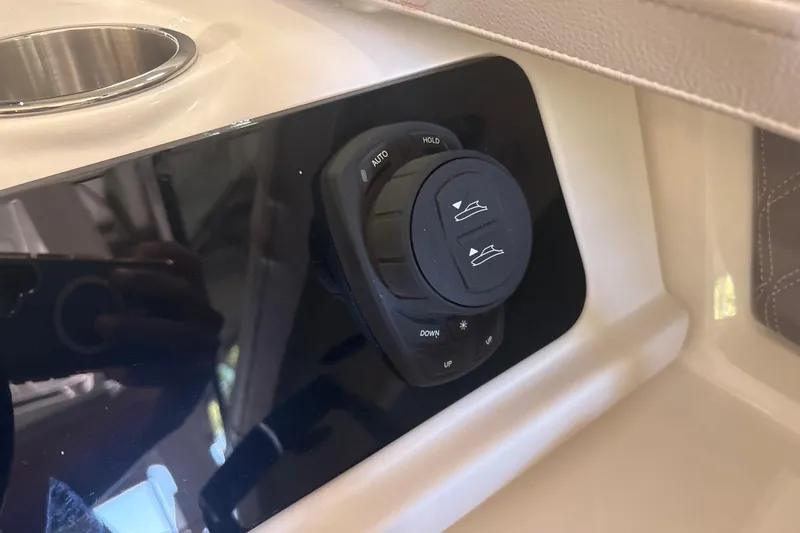 Slide: The Image of Control panel of 2026 Sea Ray SLX 310 Outboard boat, featuring adjustment buttons. - 27