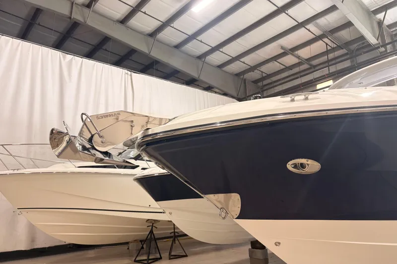 Slide: The Image of 2026 Sea Ray SLX 310 Outboard boats in indoor storage facility. - 3