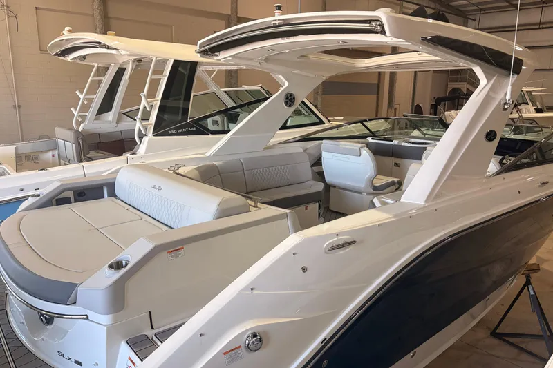Slide: The Image of 2026 Sea Ray SLX 310 Outboard boat in showroom, showcasing sleek design and luxury features. - 4