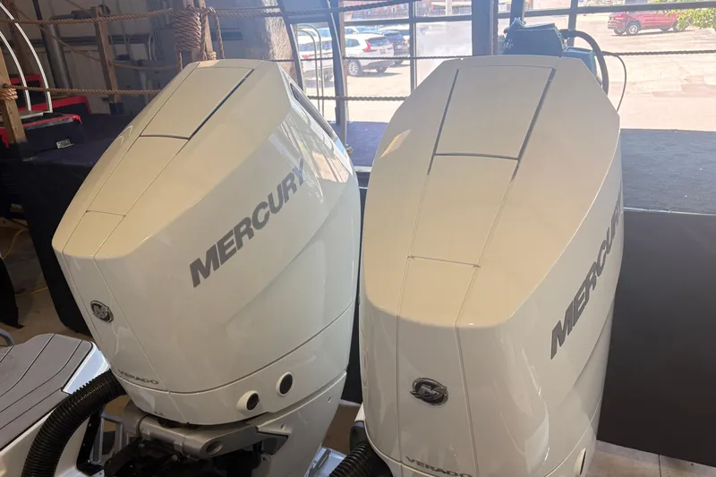 Slide: The Image of 2026 Sea Ray SLX 310 Outboard with dual Mercury Verado engines in a showroom. - 6