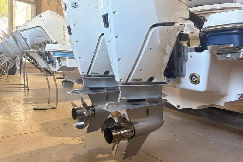 Slide: The Image of 2026 Sea Ray SLX 310 Outboard with dual Mercury engines in a showroom setting. - 7