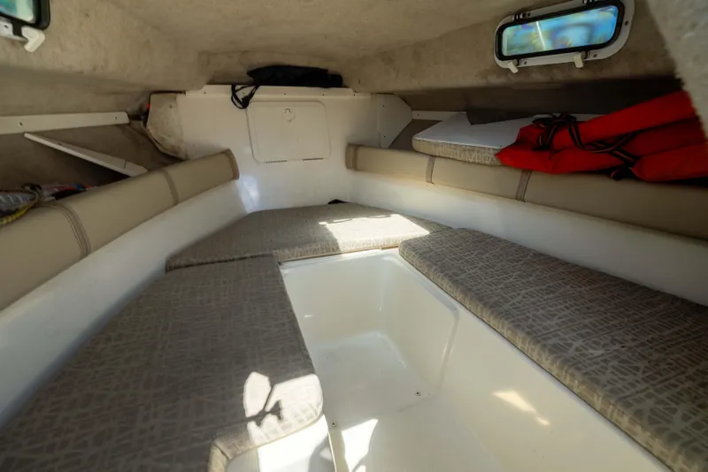 Slide: The Image of Interior cabin of a 2012 KEYWEST 2020 WA boat with cushioned seating and life jackets. - 11