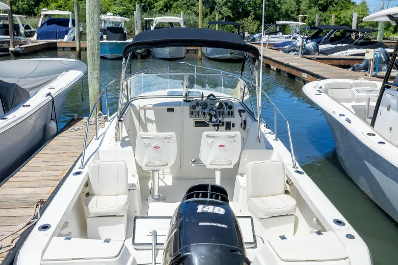 Slide: The Image of 2020 KEYWEST WA boat docked at marina, featuring spacious seating and modern controls. - 3