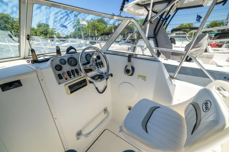Slide: The Image of Interior view of a 2012 KEYWEST 2020 WA boat cockpit with steering wheel and controls. - 5