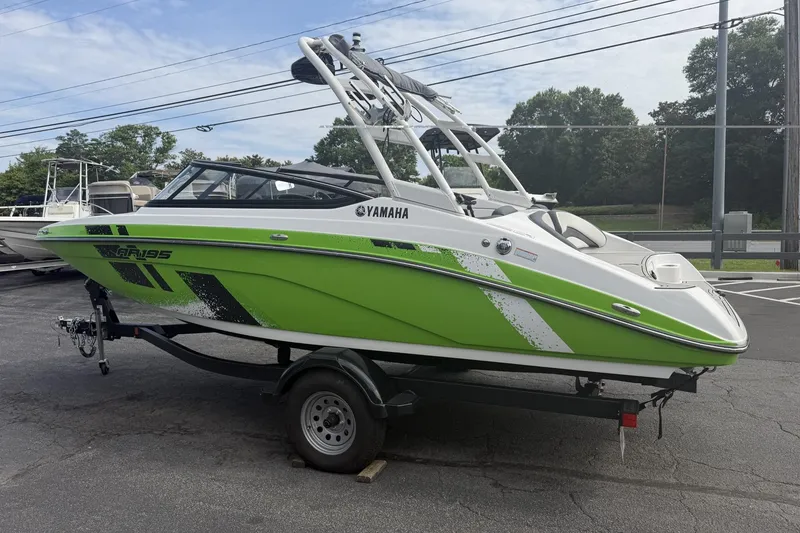 The Image of 2022 Yamaha AR195 boat in vibrant green on trailer, parked outdoors. - 0