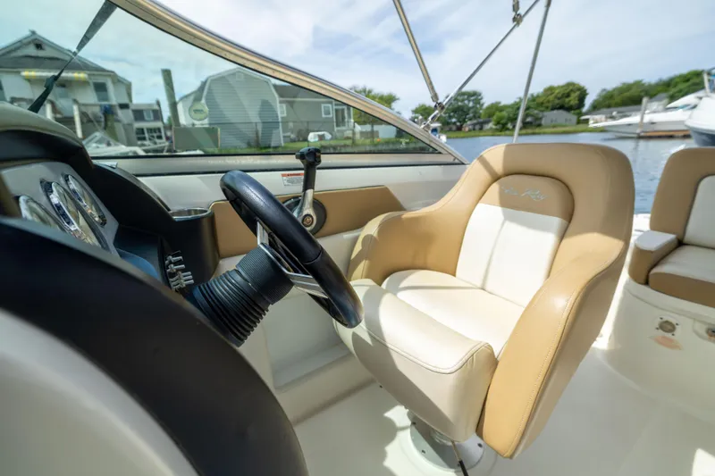 Slide: The Image of Interior of 2011 Sea Ray 220 Sundeck boat with steering wheel and captain's chair. - 15