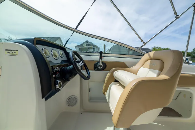 Slide: The Image of Interior view of 2011 Sea Ray 220 Sundeck boat cockpit with steering wheel and controls. - 13