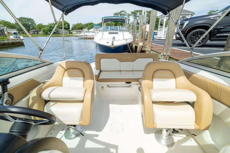 Slide: The Image of Interior of a 2011 Sea Ray 220 Sundeck boat with beige seating. - 9