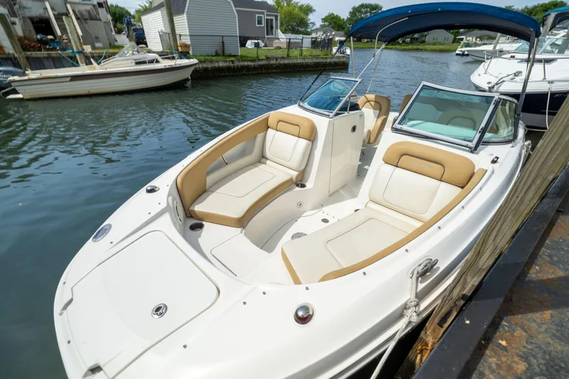 Slide: The Image of 2011 Sea Ray 220 Sundeck boat docked, featuring spacious seating and sleek design. - 3