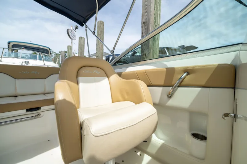 Slide: The Image of Interior of 2011 Sea Ray 220 Sundeck boat with tan and white seating. - 17