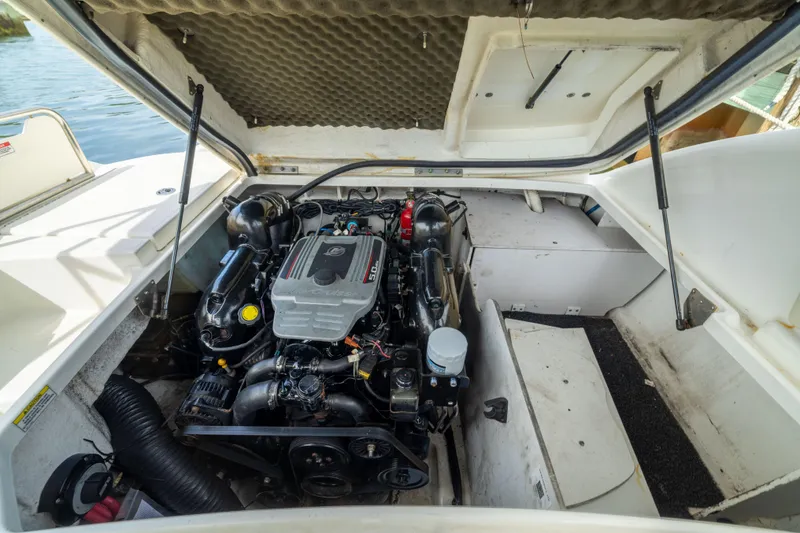 Slide: The Image of Engine compartment of a 2011 Sea Ray 220 Sundeck boat, showcasing the motor details. - 21