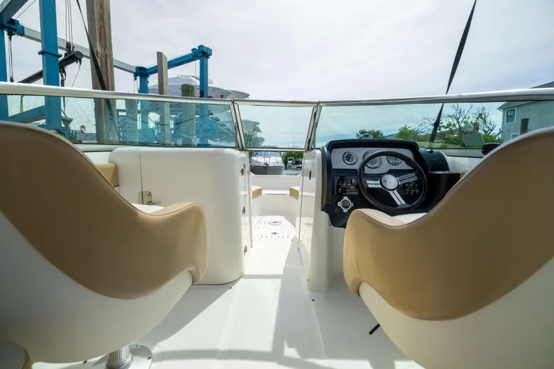 Slide: The Image of Interior view of 2011 Sea Ray 220 Sundeck boat with steering wheel and seating. - 10