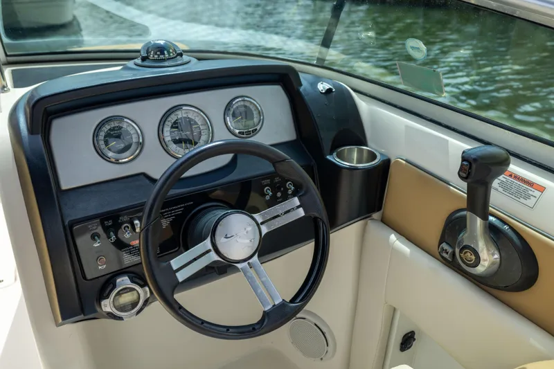 Slide: The Image of Steering console of a 2011 Sea Ray 220 Sundeck boat with gauges and controls. - 16