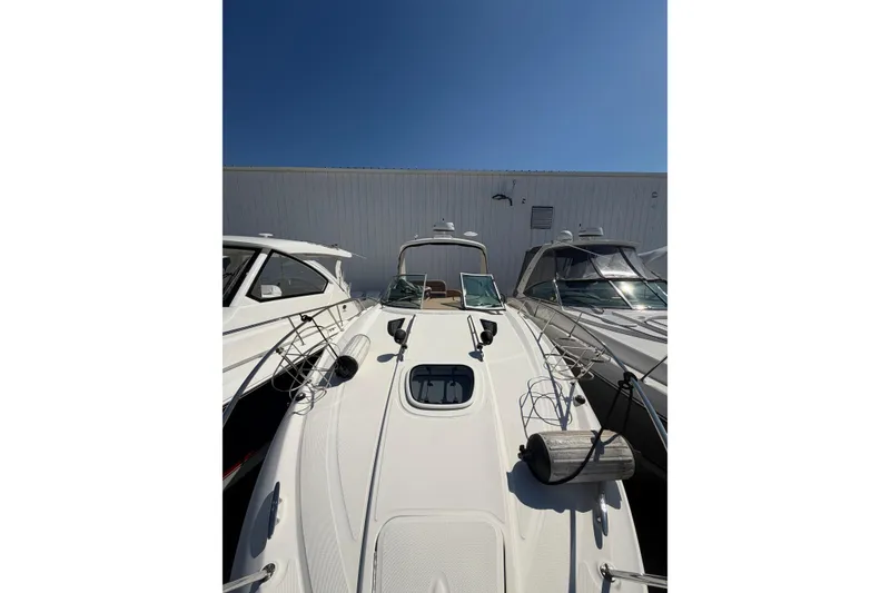 Slide: The Image of 2016 Sea Ray Sundancer 330 yacht docked under clear blue sky. - 17