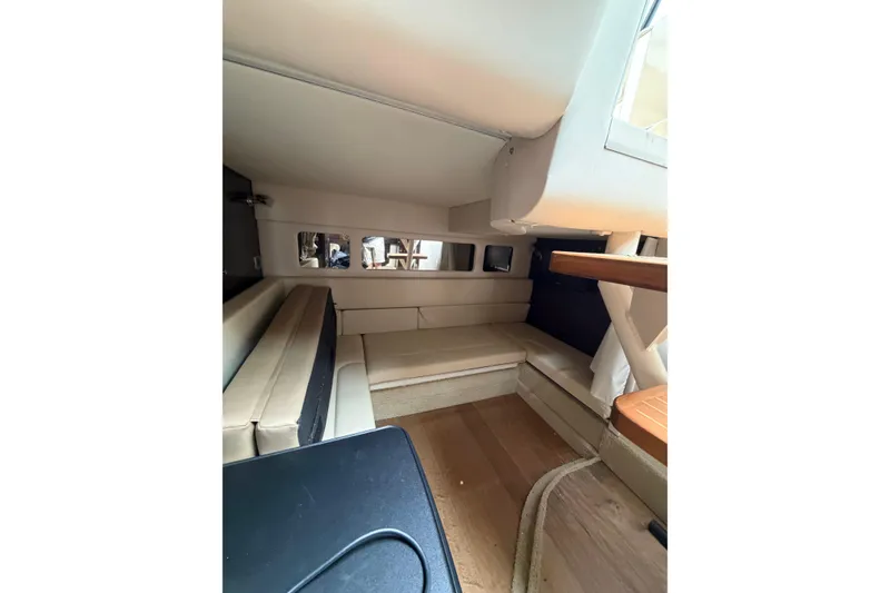 Slide: The Image of Interior cabin of 2016 Sea Ray Sundancer 330, featuring beige seating and wooden accents. - 22