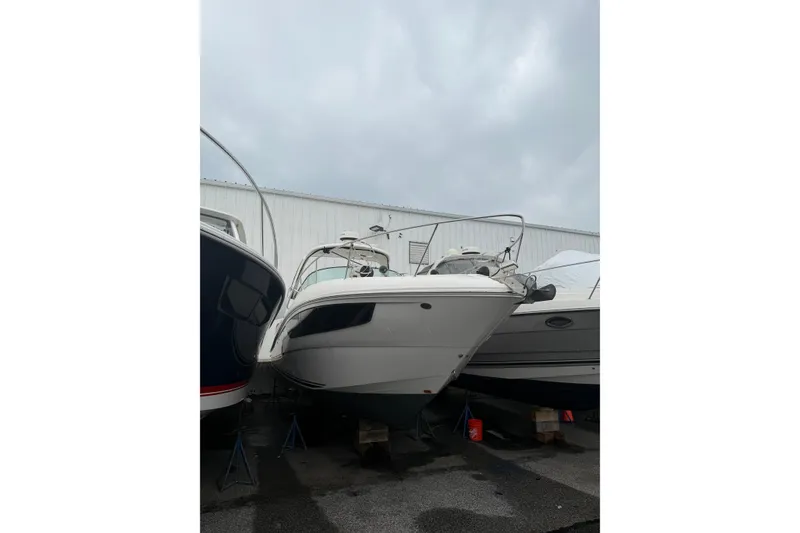 Slide: The Image of 2016 Sea Ray Sundancer 330 boat in storage, surrounded by other vessels. - 36