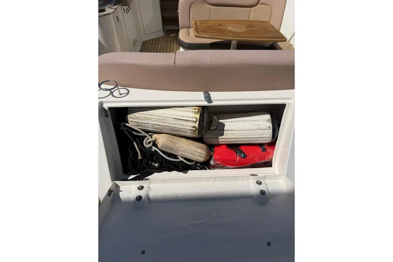 Slide: The Image of Storage compartment on 2016 Sea Ray Sundancer 330 boat with fenders and ropes. - 20