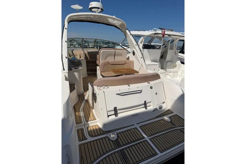 Slide: The Image of 2016 Sea Ray Sundancer 330 yacht interior with seating and wooden flooring. - 3