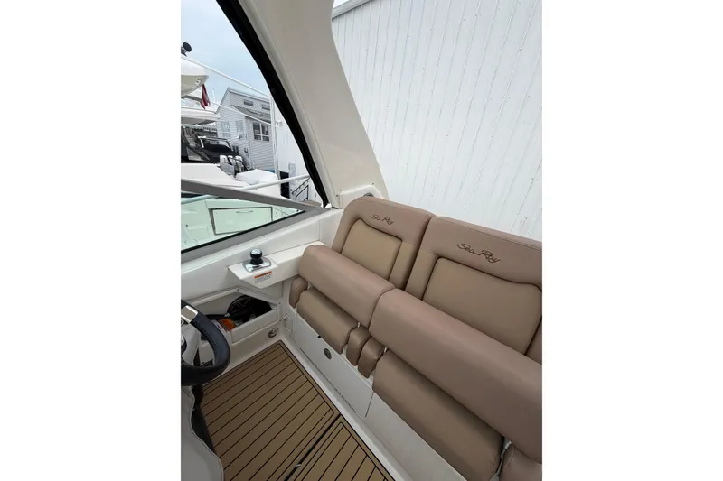 Slide: The Image of 2016 Sea Ray Sundancer 330 interior with tan seating and wood-style flooring. - 33