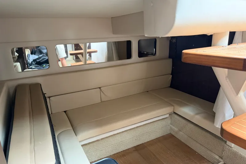 Slide: The Image of Interior of 2016 Sea Ray Sundancer 330 with beige seating and wooden accents. - 23